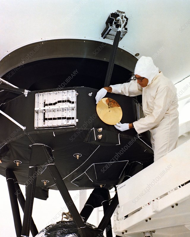 scientist attaching golden record on spacecraft